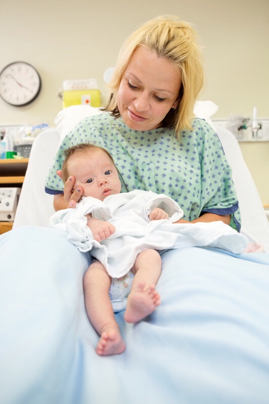 Mother holding newborn baby.