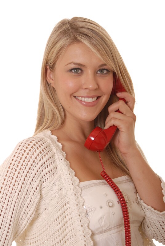 Girl talking on corded phone.