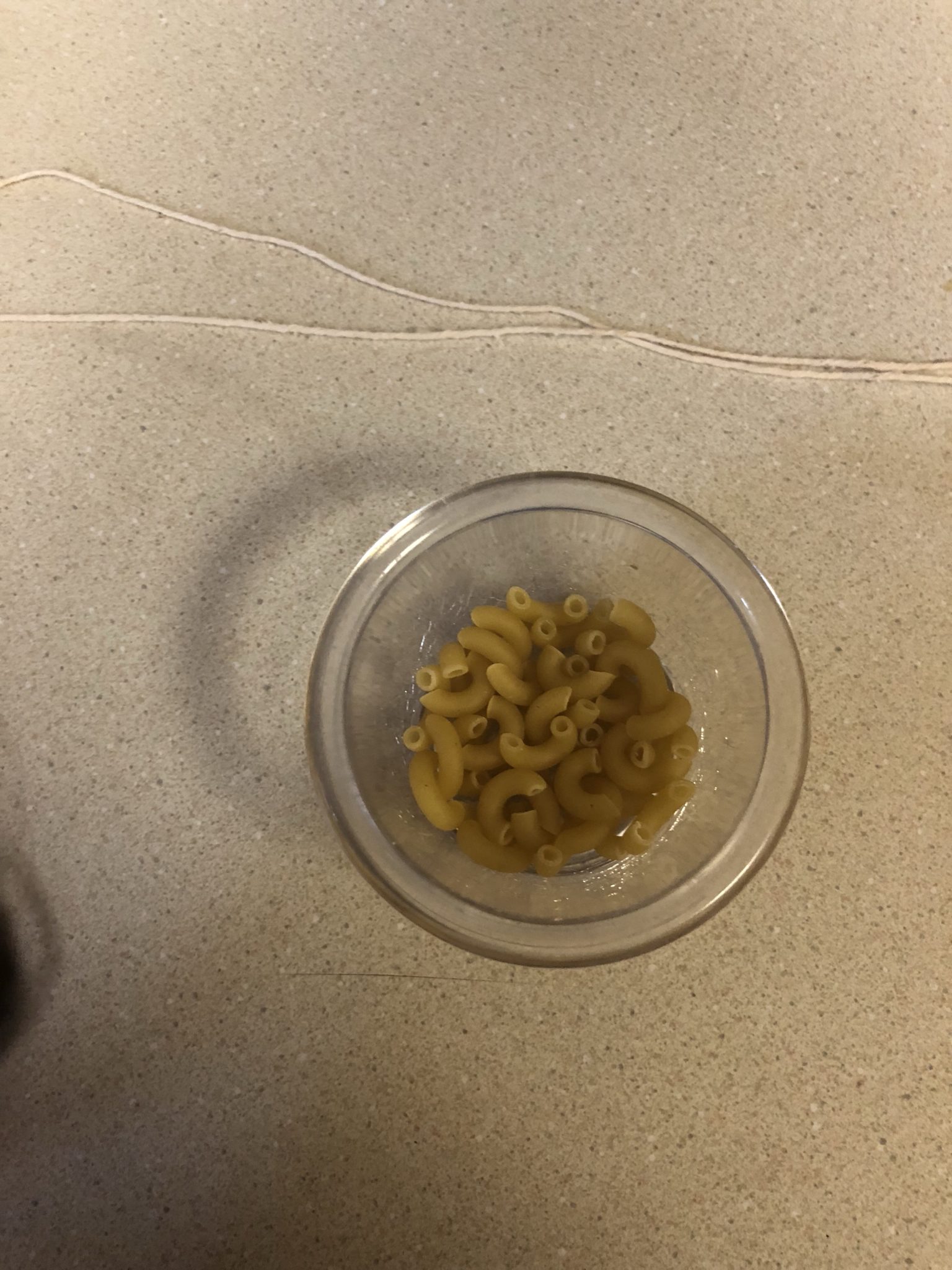 Small cup of macaroni with the string above it.