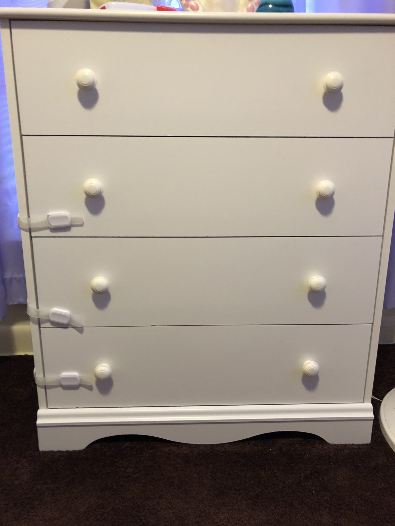 A dresser with locks on the drawers.