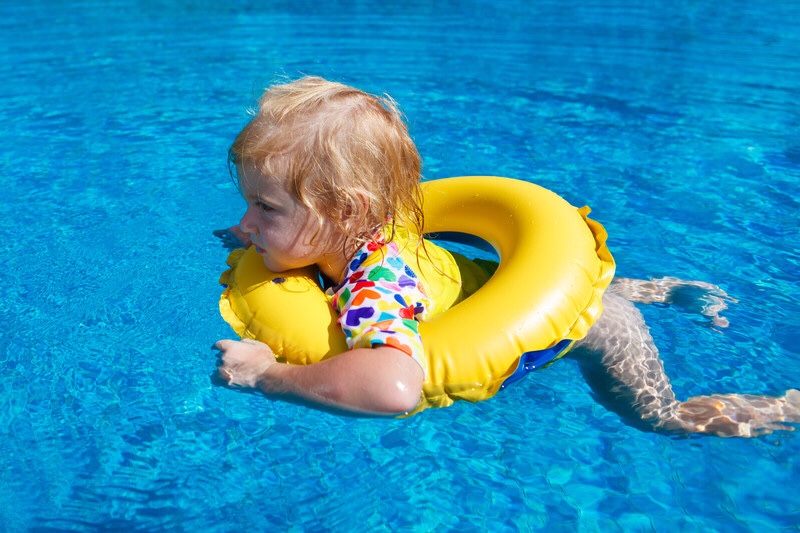 Baby in a pool on a float.