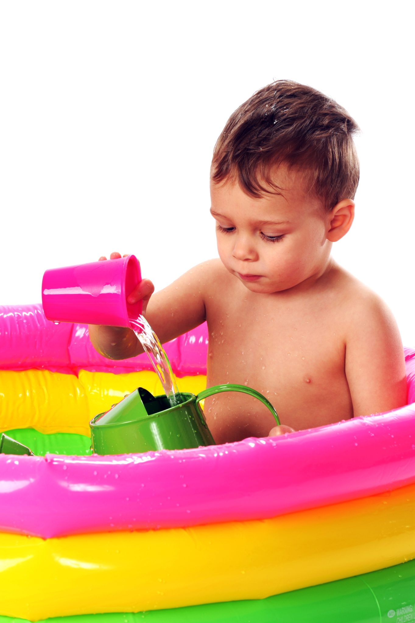 Child pouring water at a water table.