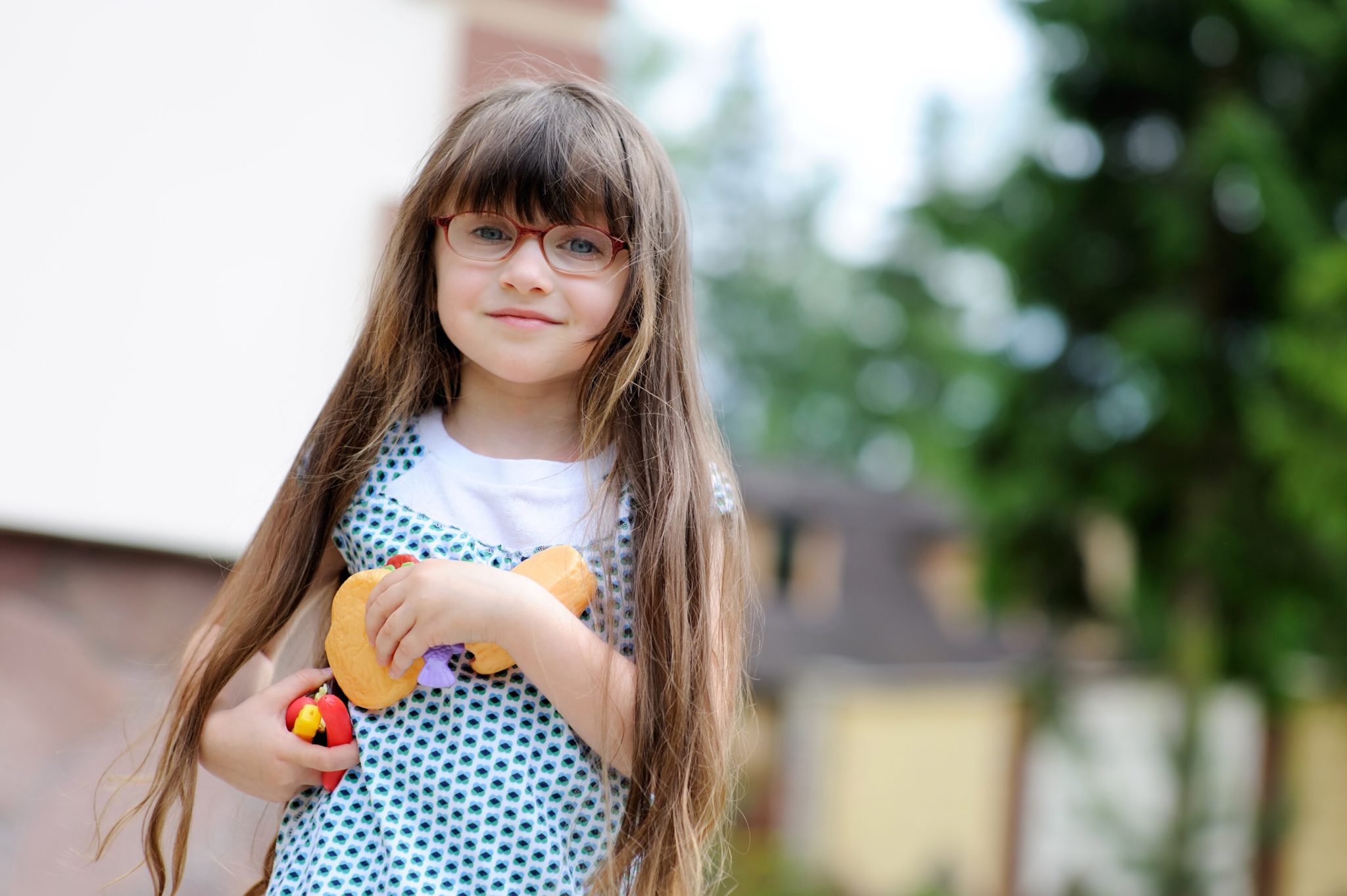 Little girl playing with pretend food.