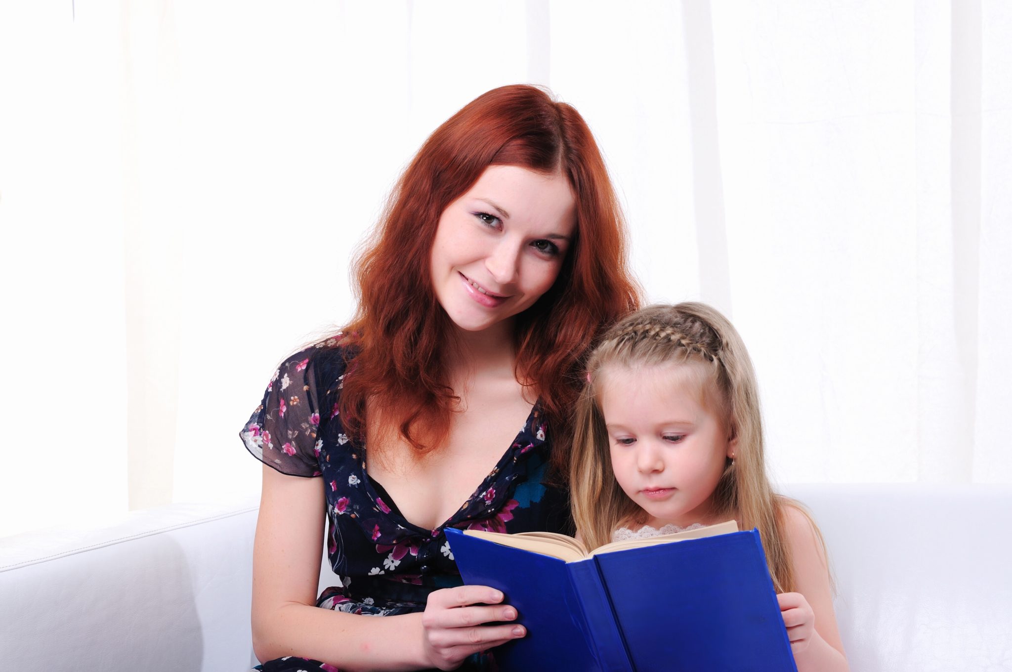 Mother and daughter reading a book.