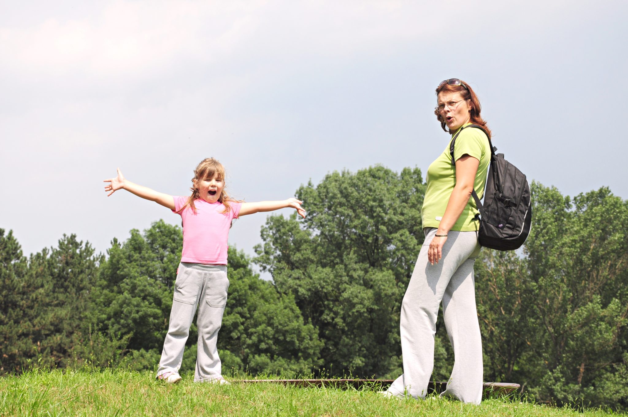 Mother and daughter walking outside.