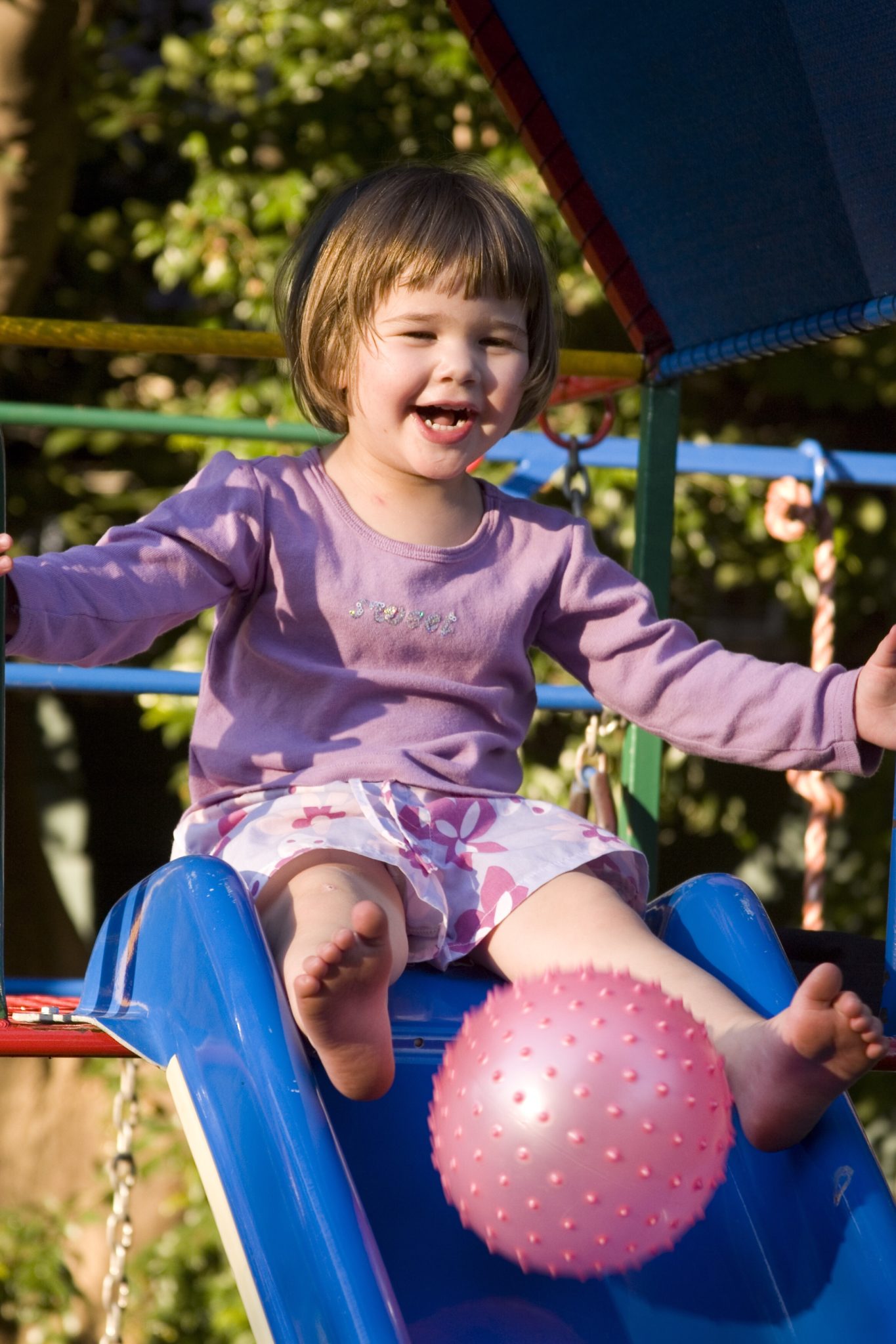 Toddler playing on slide.