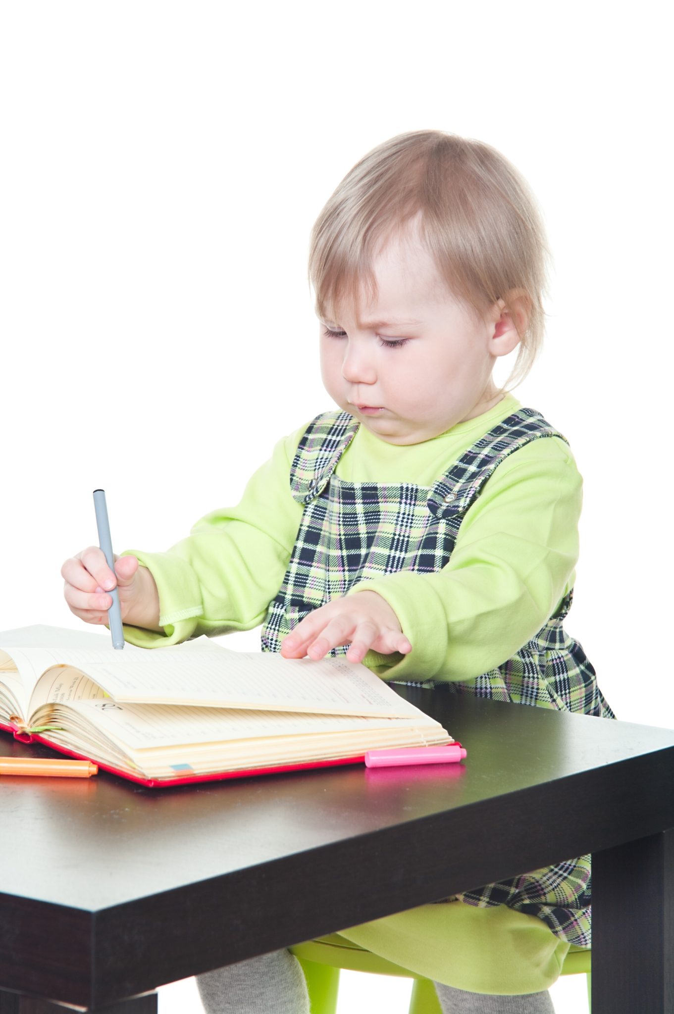 Girl drawing in book.