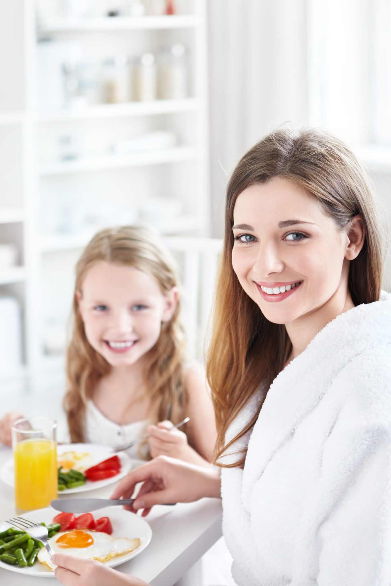 Mother and daughter having breakfast.