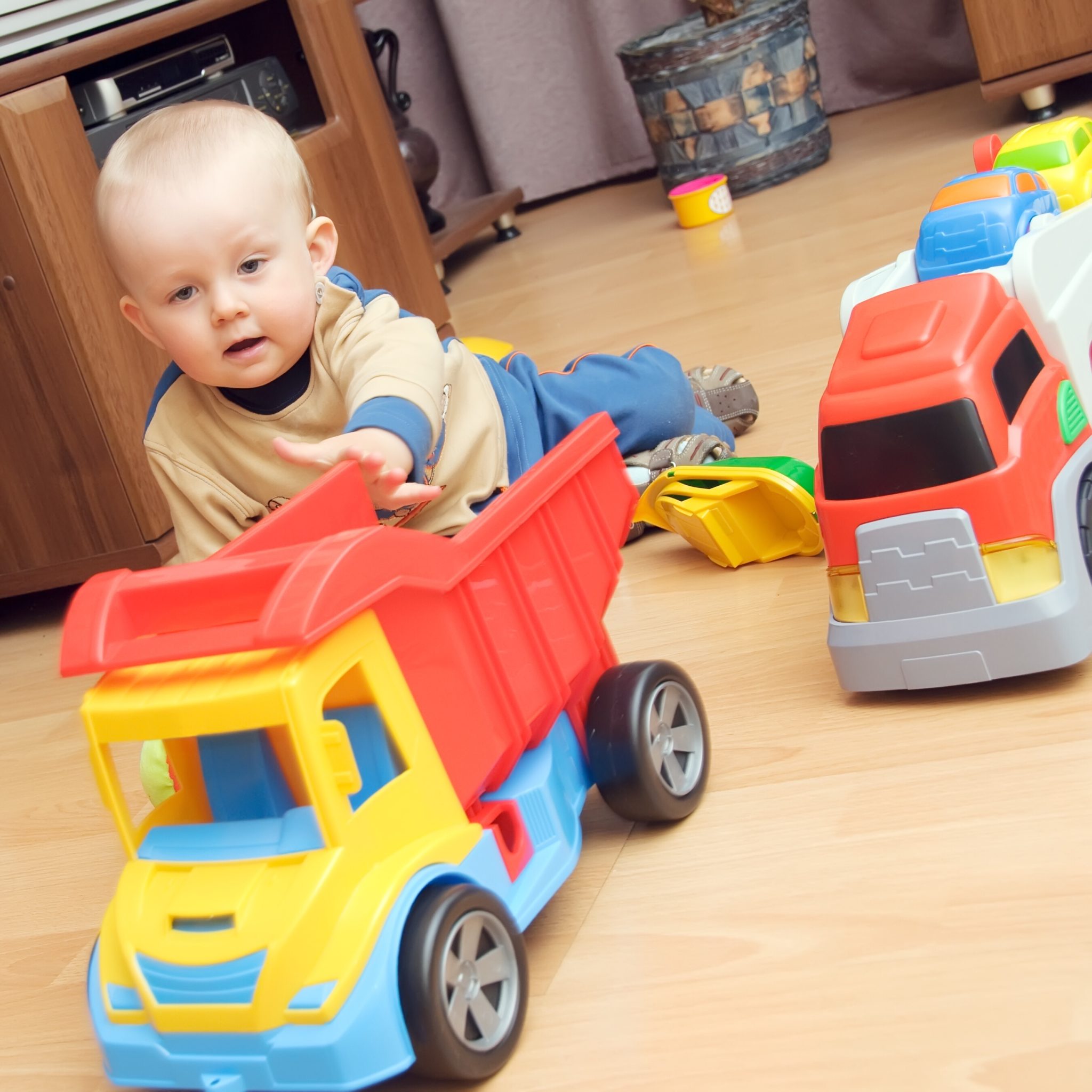 Boy playing with trucks.