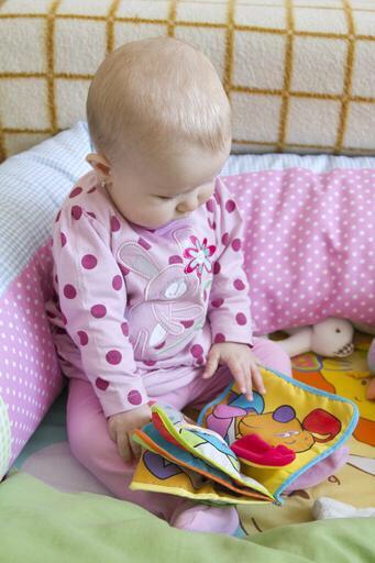 Baby reading book.