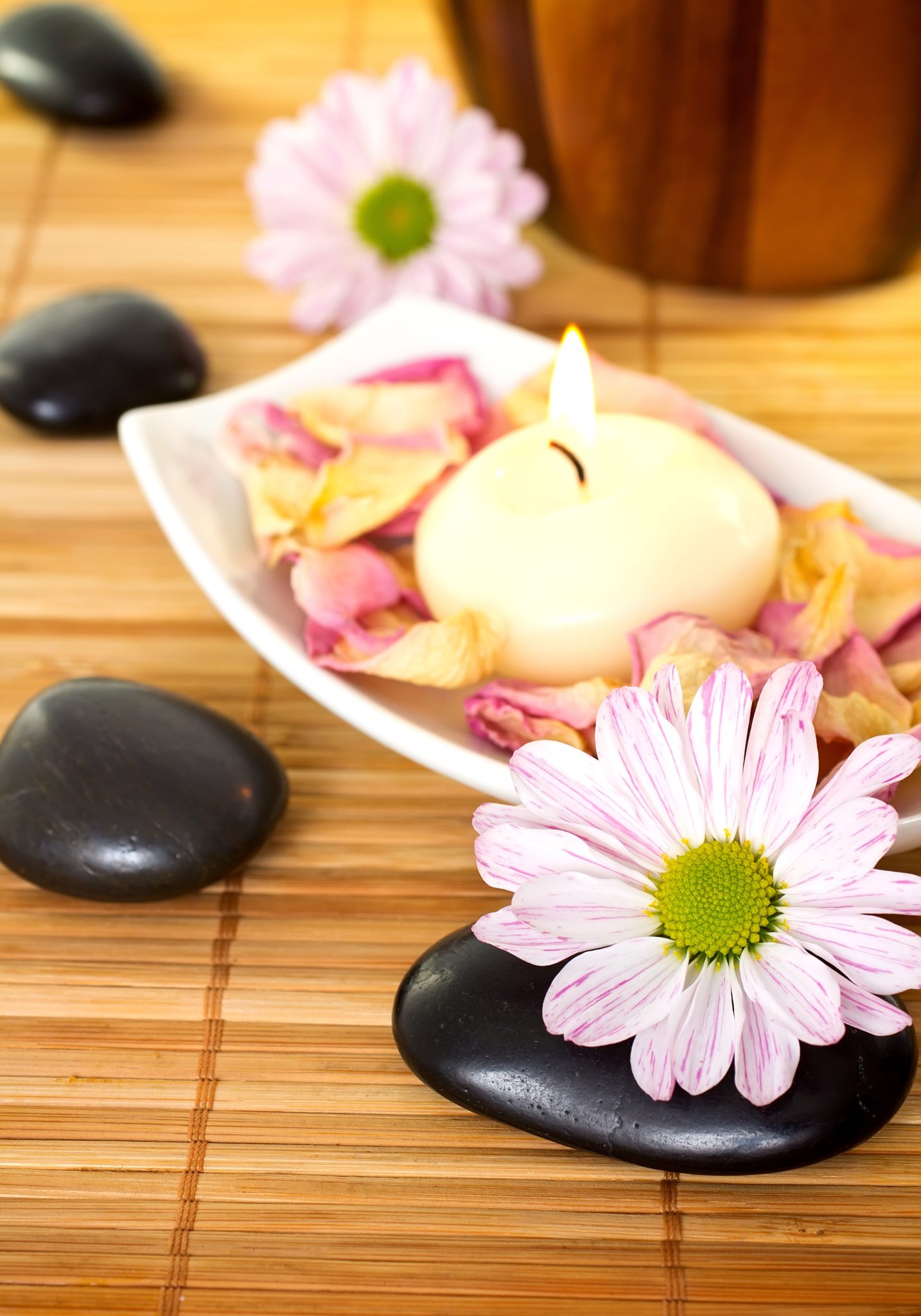 Spa treatment with stones, candles and flowers.