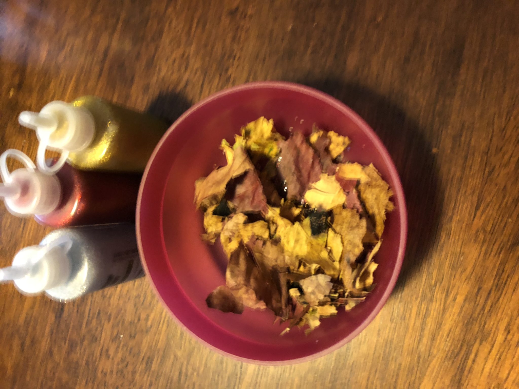 Crushed leaves and glitter in a bowl.