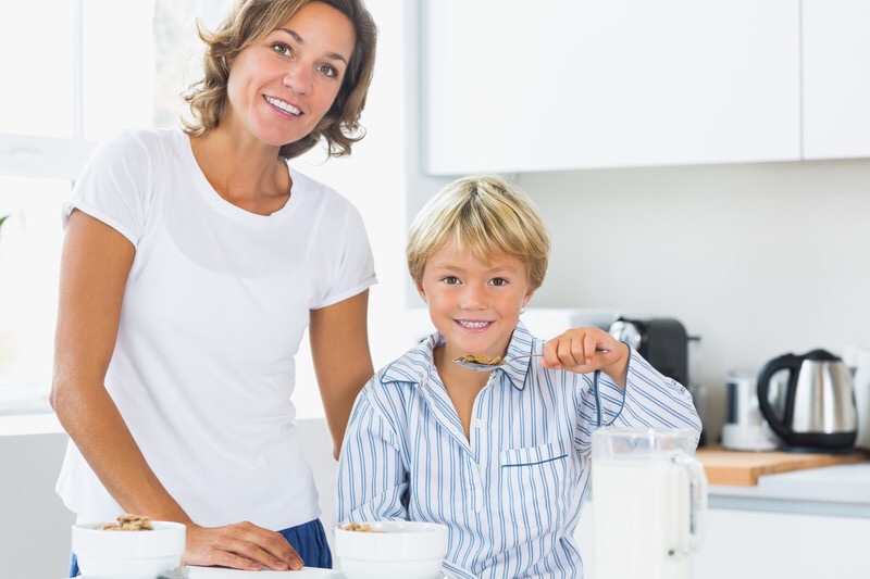 Mother and son eating breakfast.