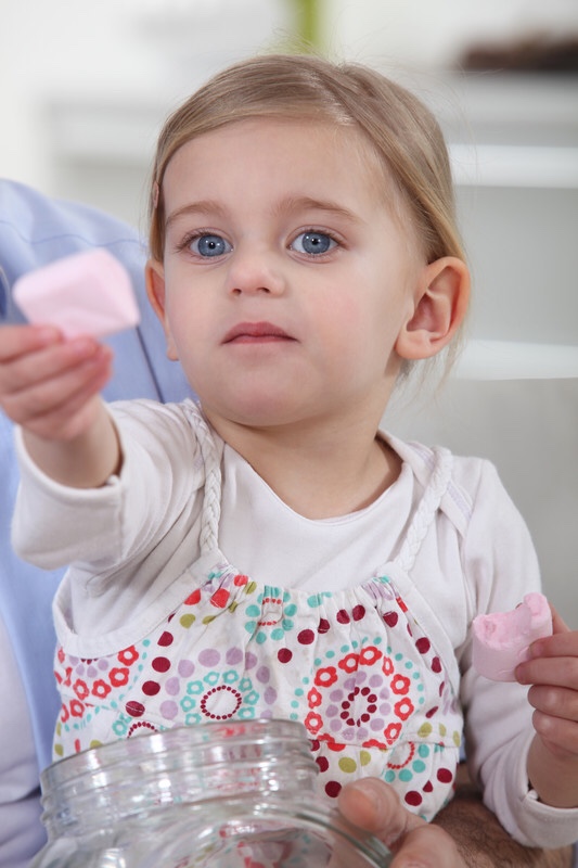 Girl offering marshmallows