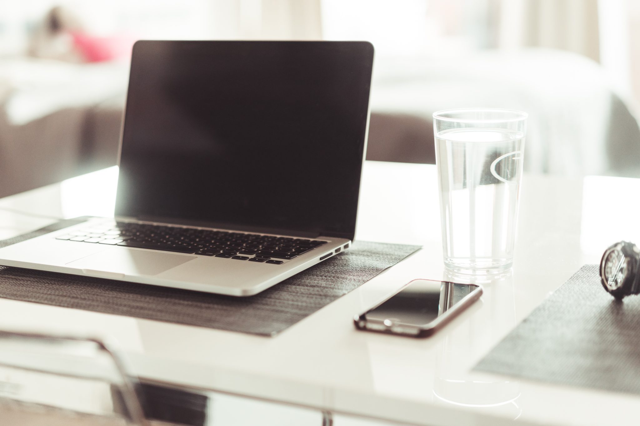 A Mac book next to an iPhone, showing technology concept.