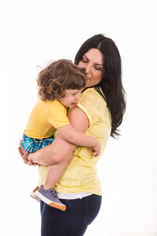 Mother holding crying toddler