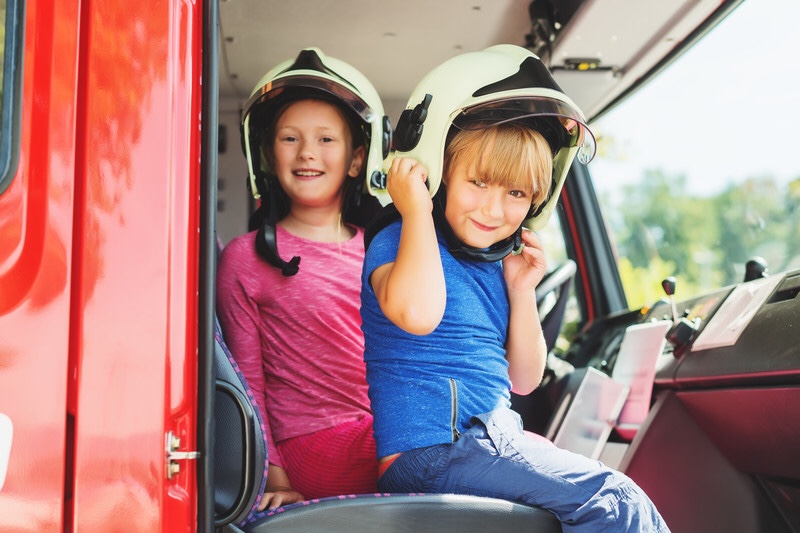 Children playing in fire truck learning about fire safety