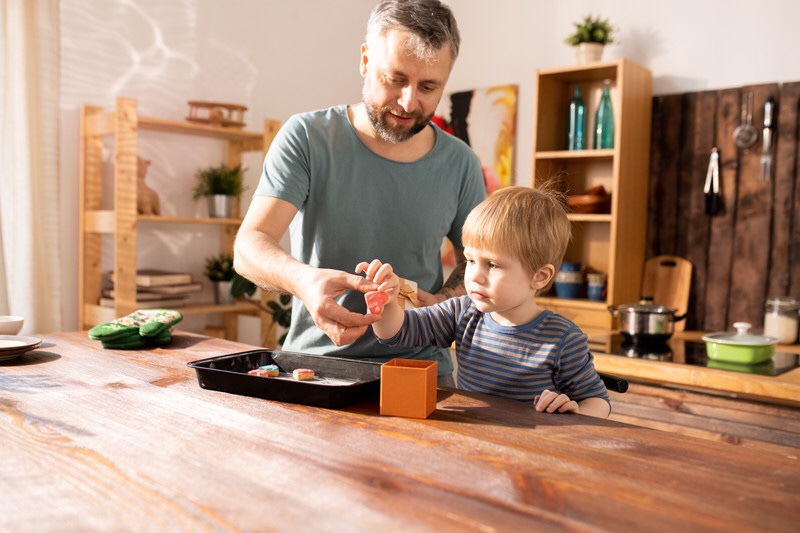 Father and son making Valentines gift for mom