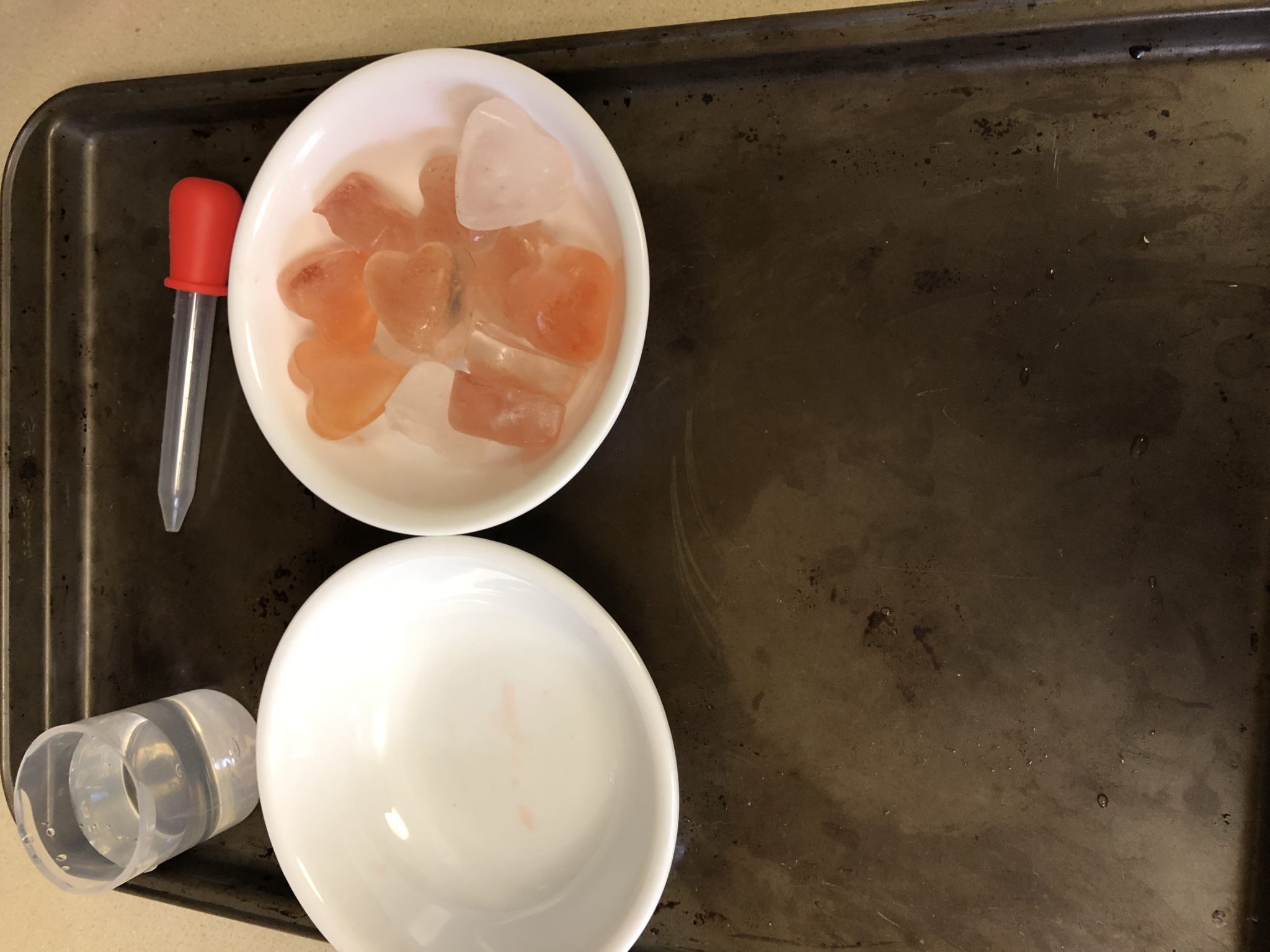 Tray with melting hearts ice and bowls