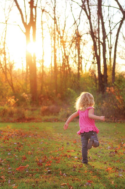 Little girl running in field