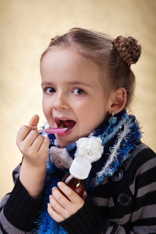 Little girl taking medicine