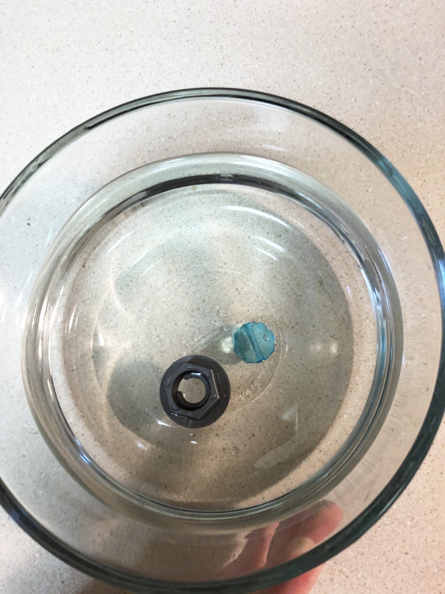 Plastic nut floating in water.