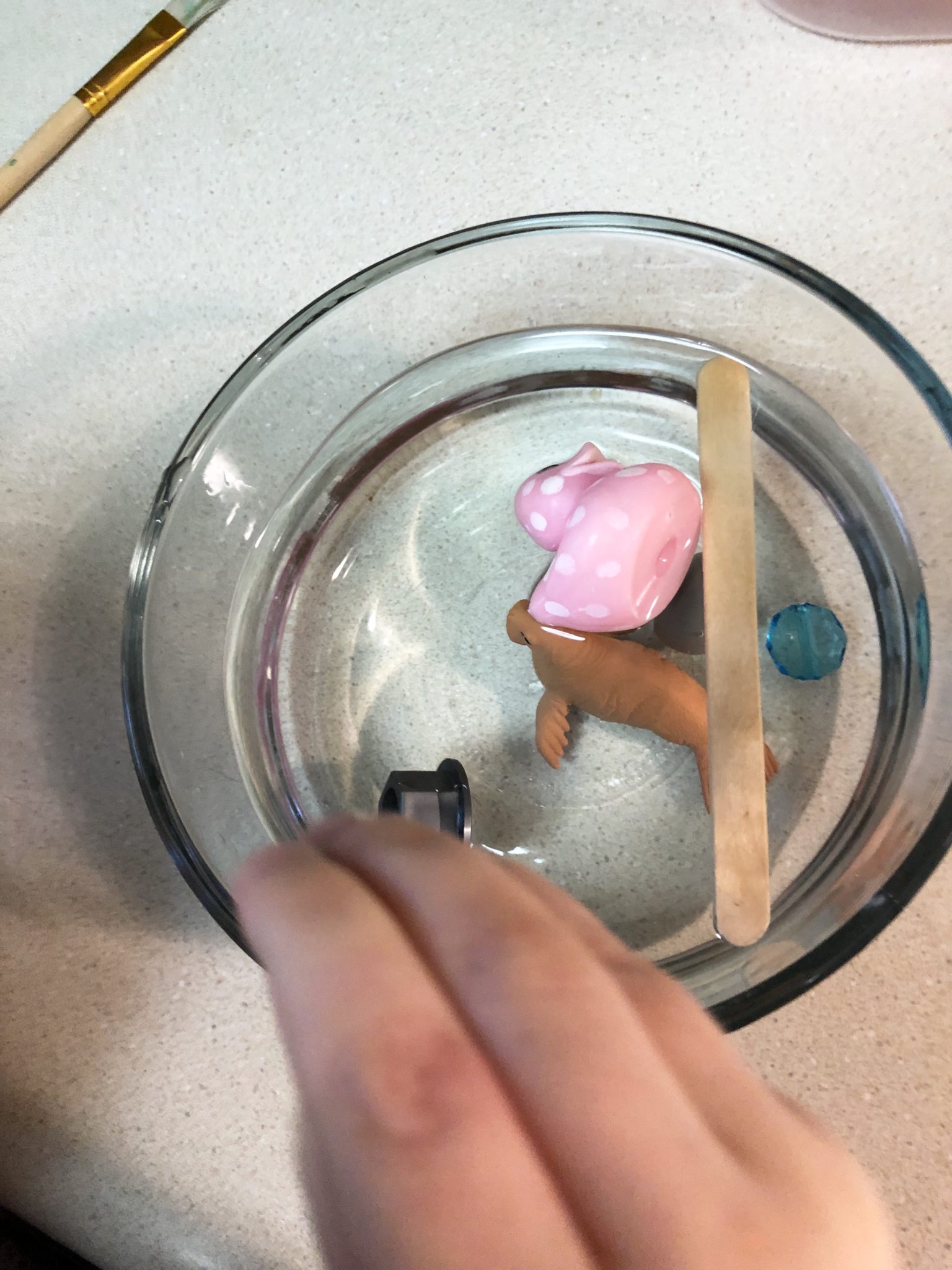 Rosebud adding objects to the bowl.