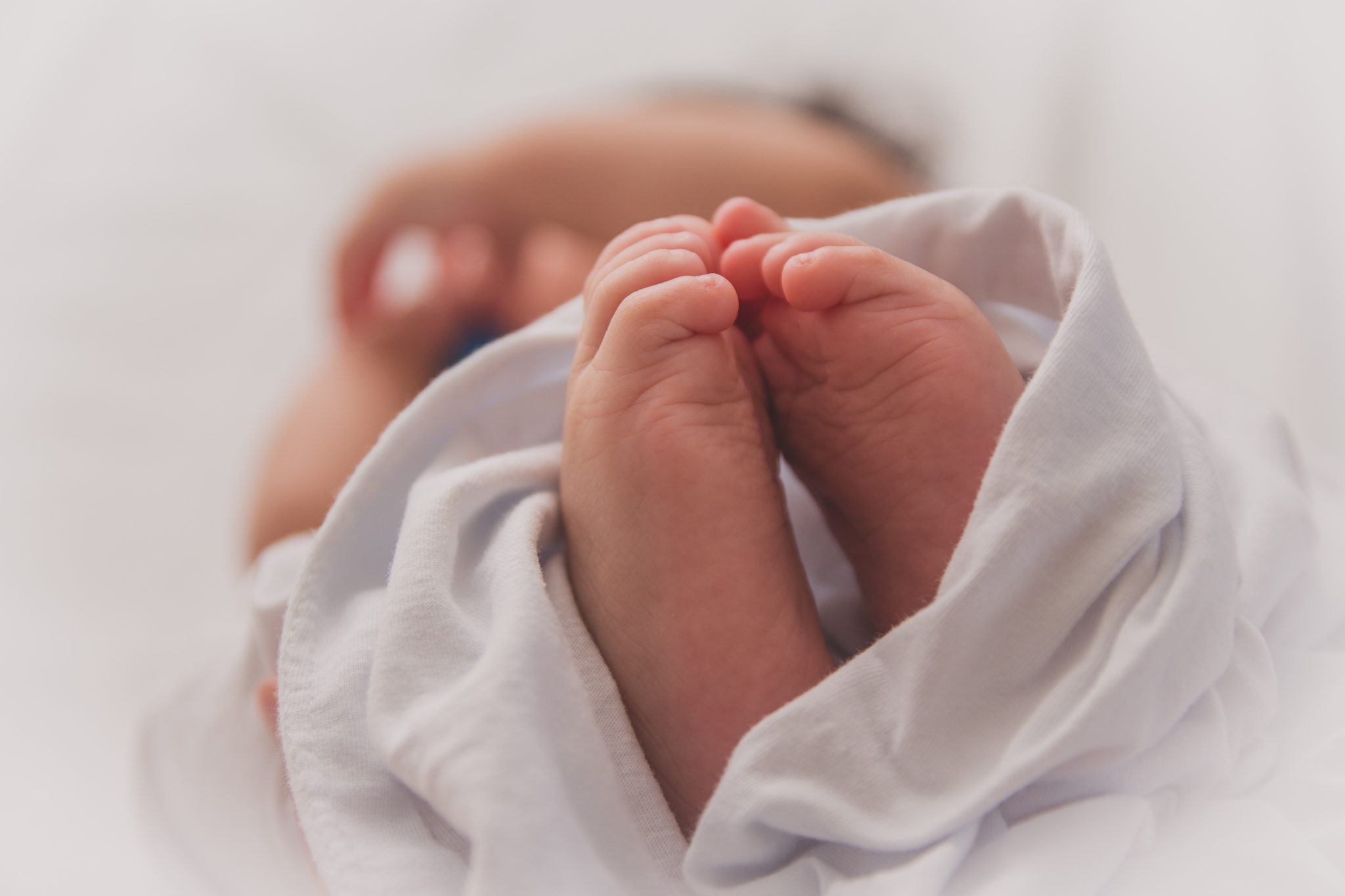 Hand holding baby feet