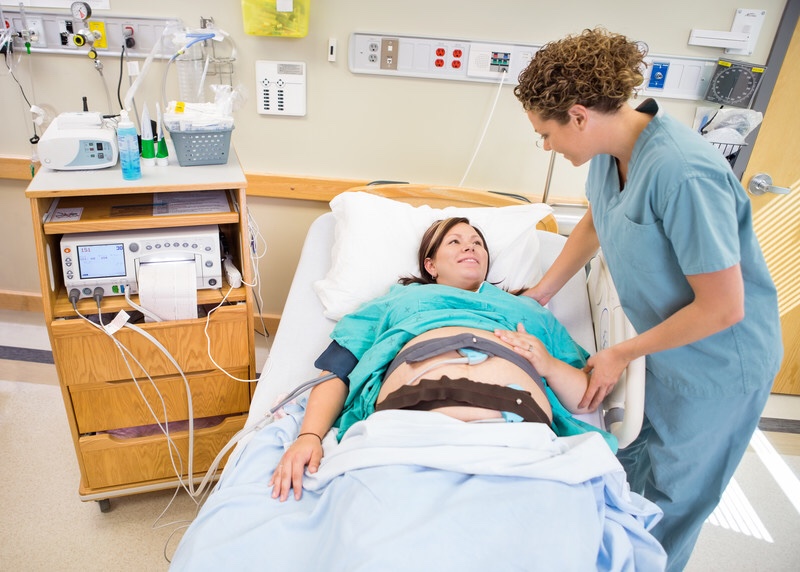 Pregnant woman with nurse in the hospital