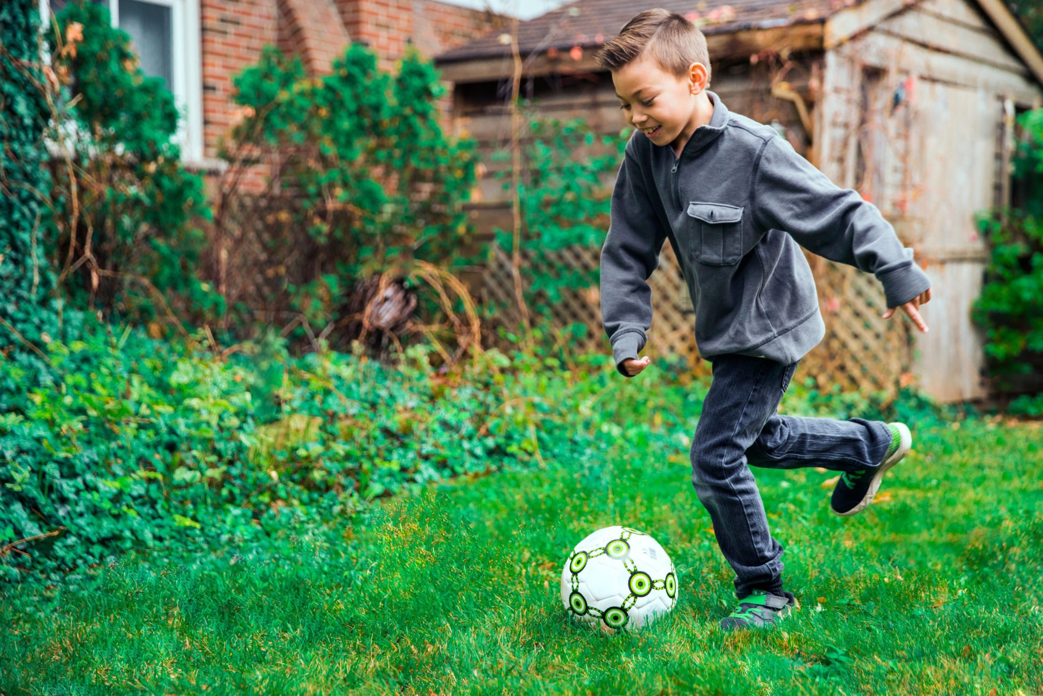 Boy kicking soccer ball