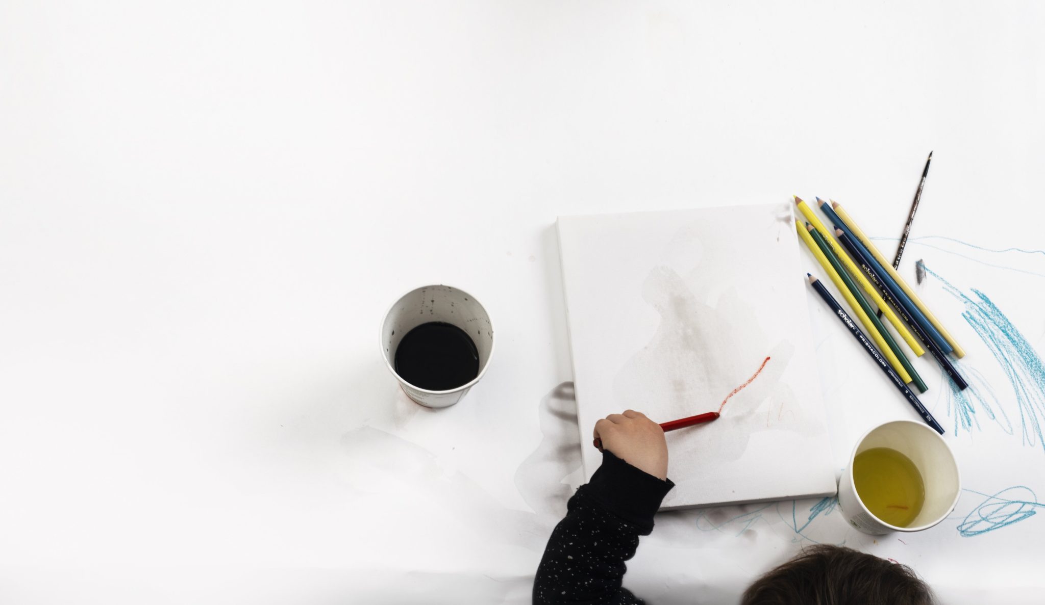 Child painting with art supplies