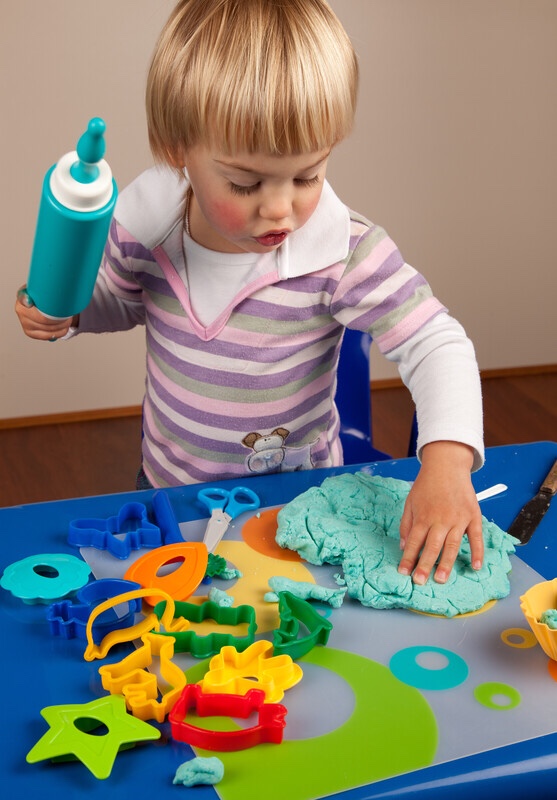 Little girl playing with play-dough