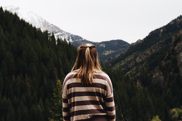 A thoughtful woman looking towards a mountain