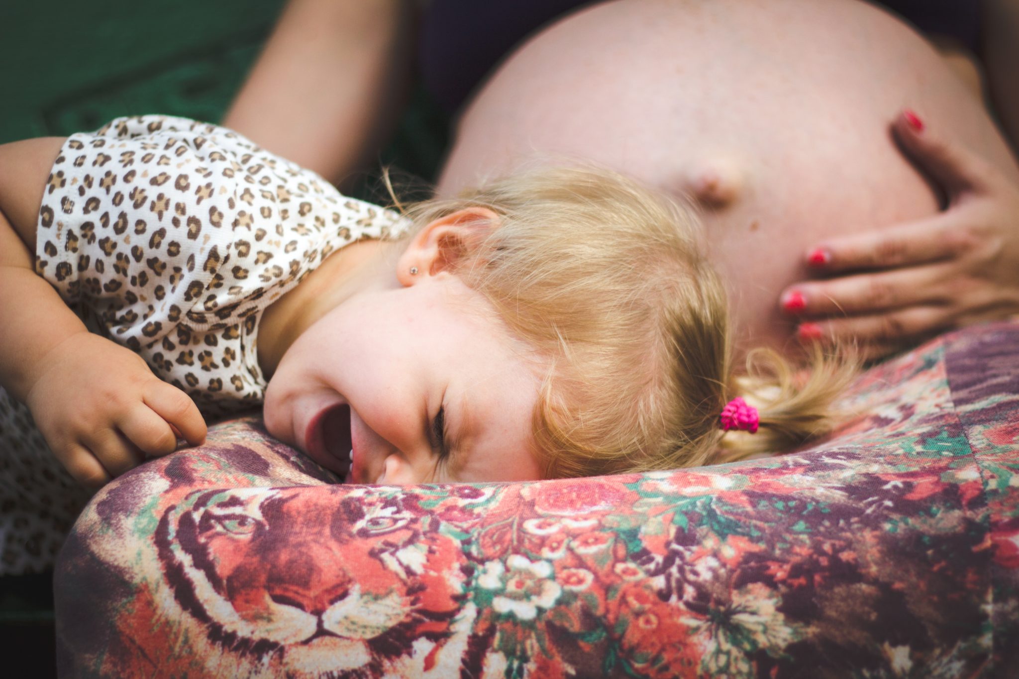 Girl crying on woman’s lap