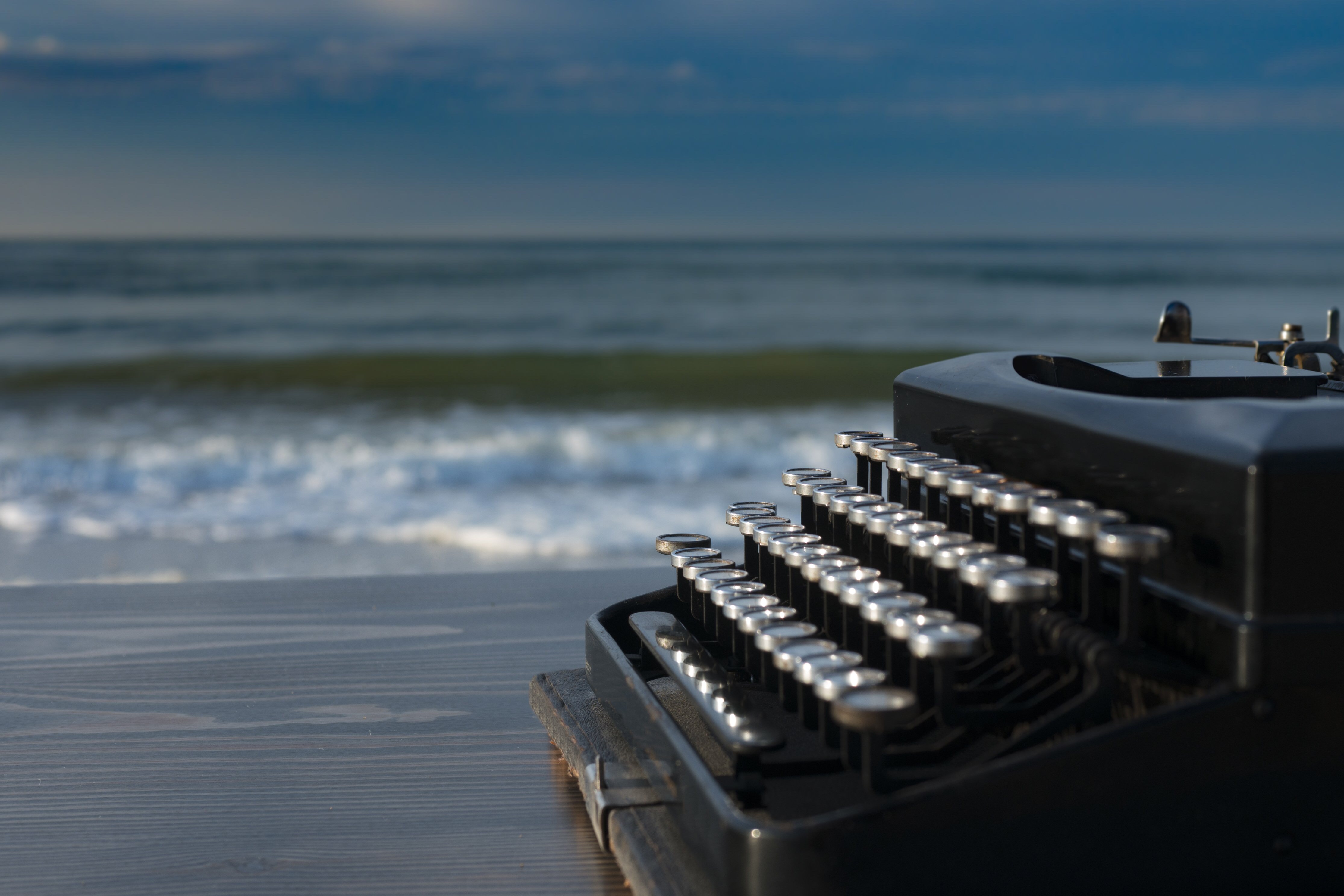 Vintage type writer on a beach.