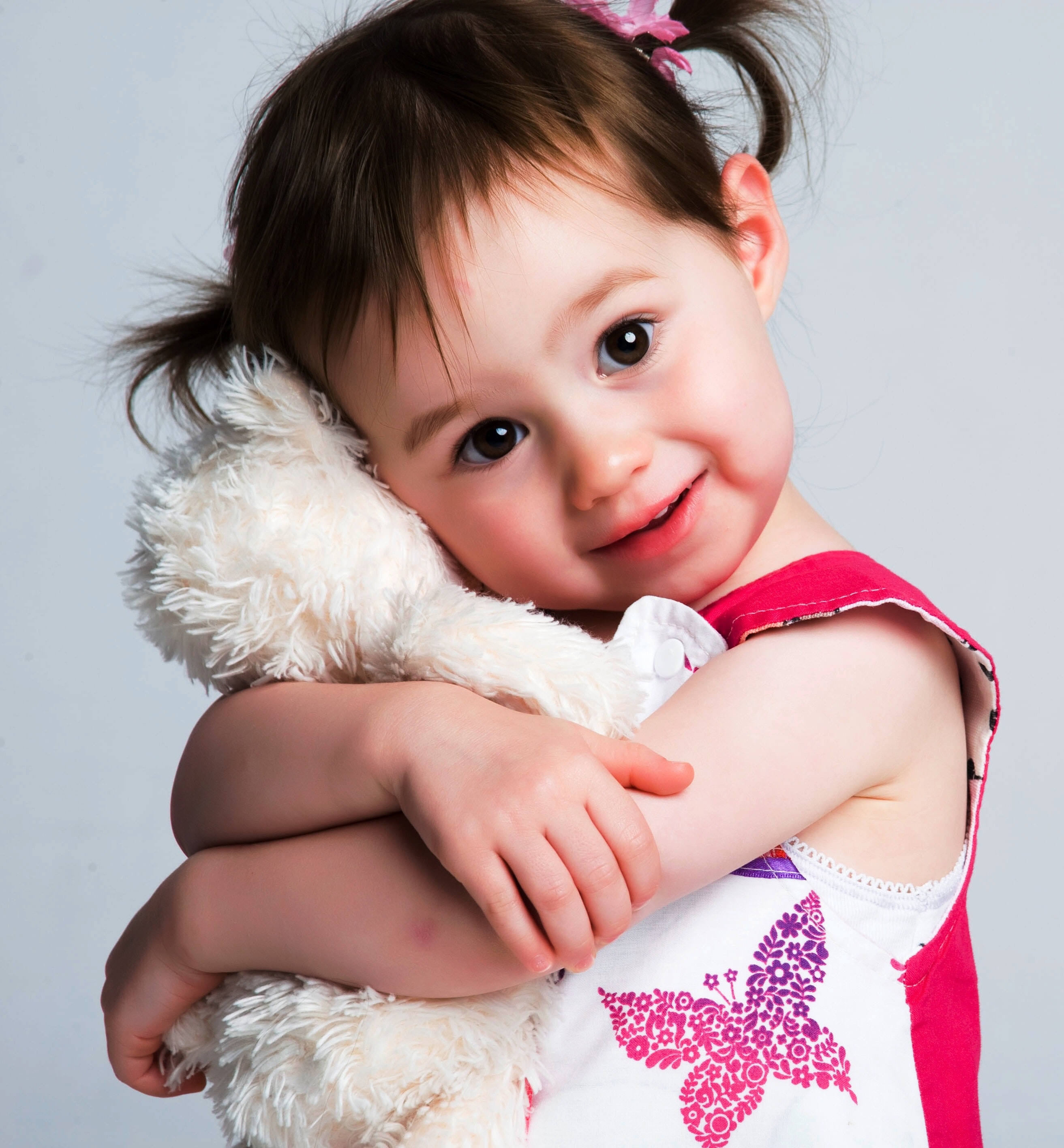 Little girl hugging stuffed animal