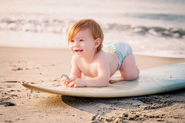 Surfer baby on beach
