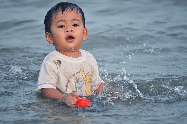 Baby sitting on beach