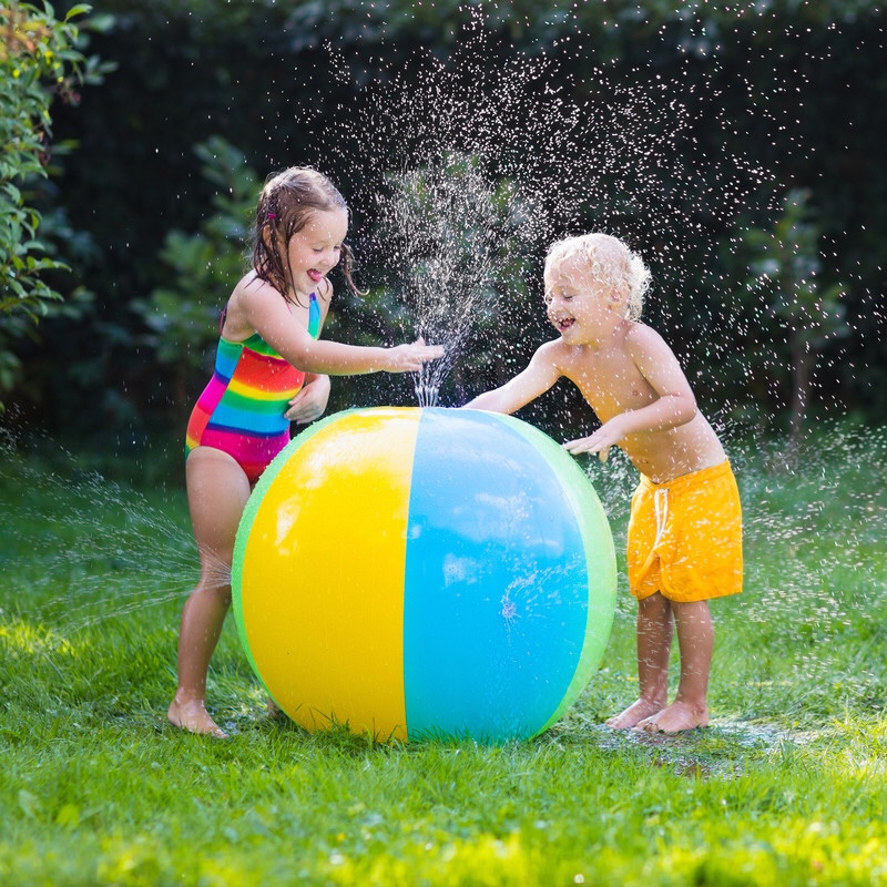 Two children playing with water ball