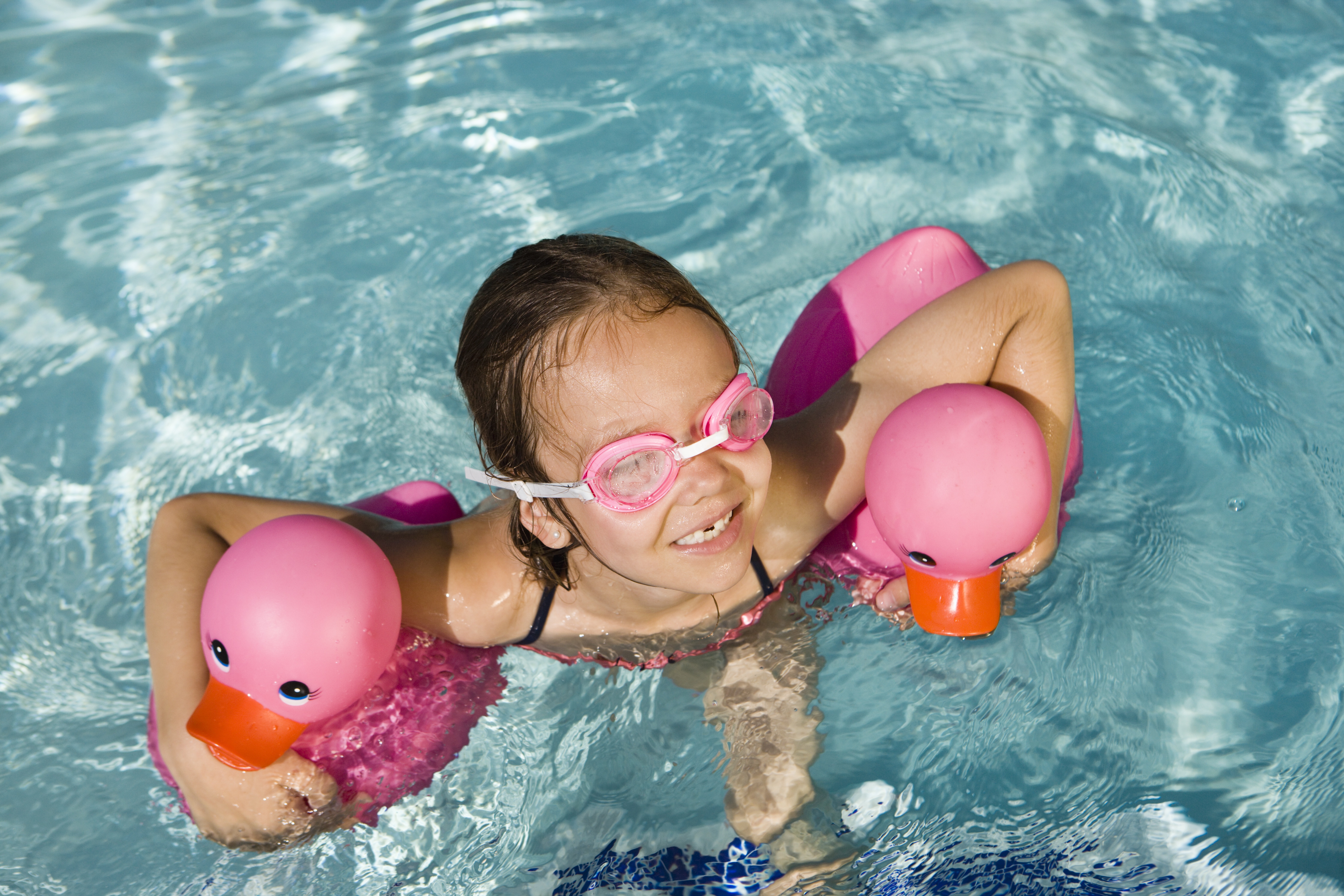 Girl Floating with two rubber ducks