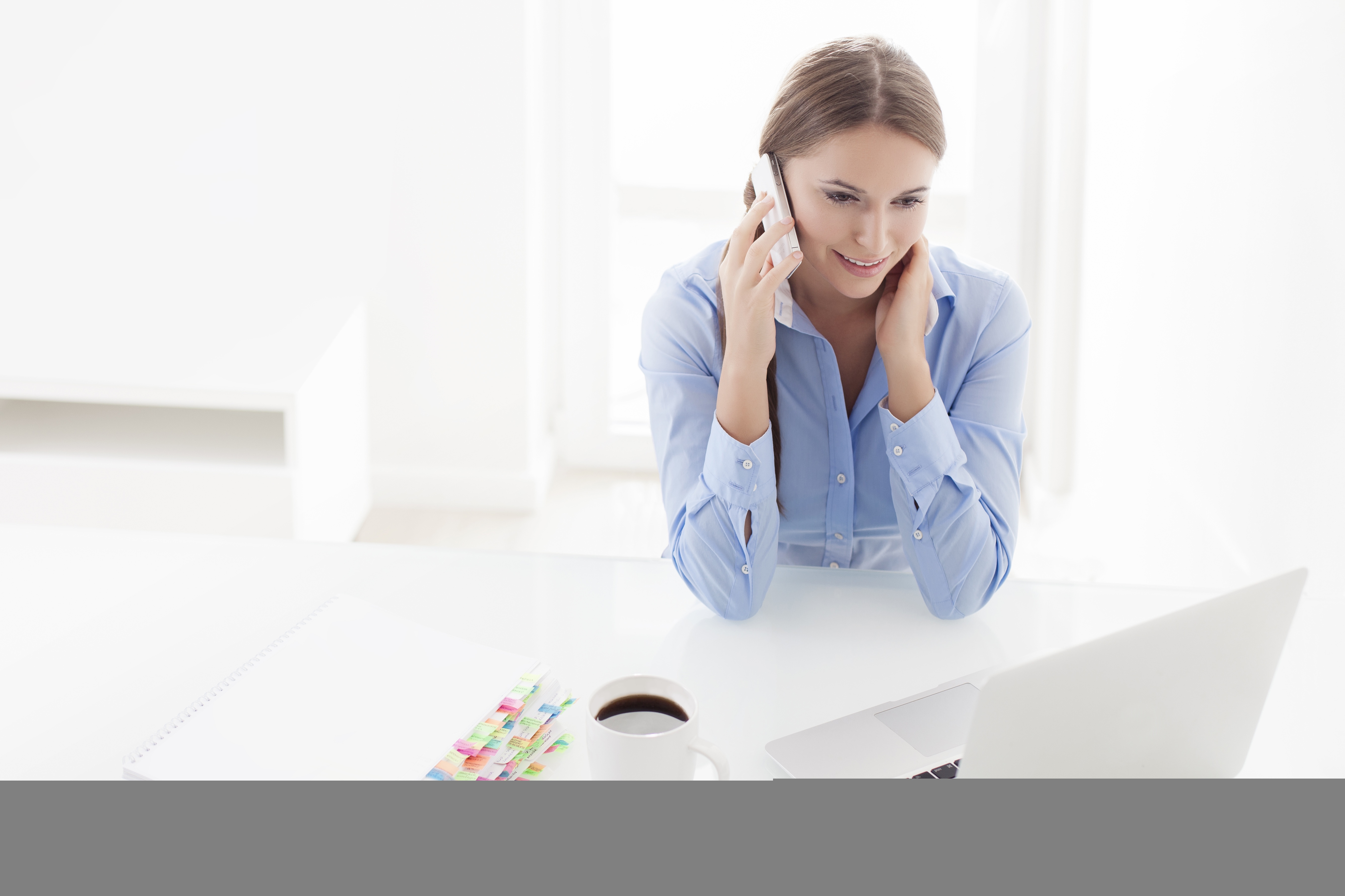 Woman with computer and mobile phone