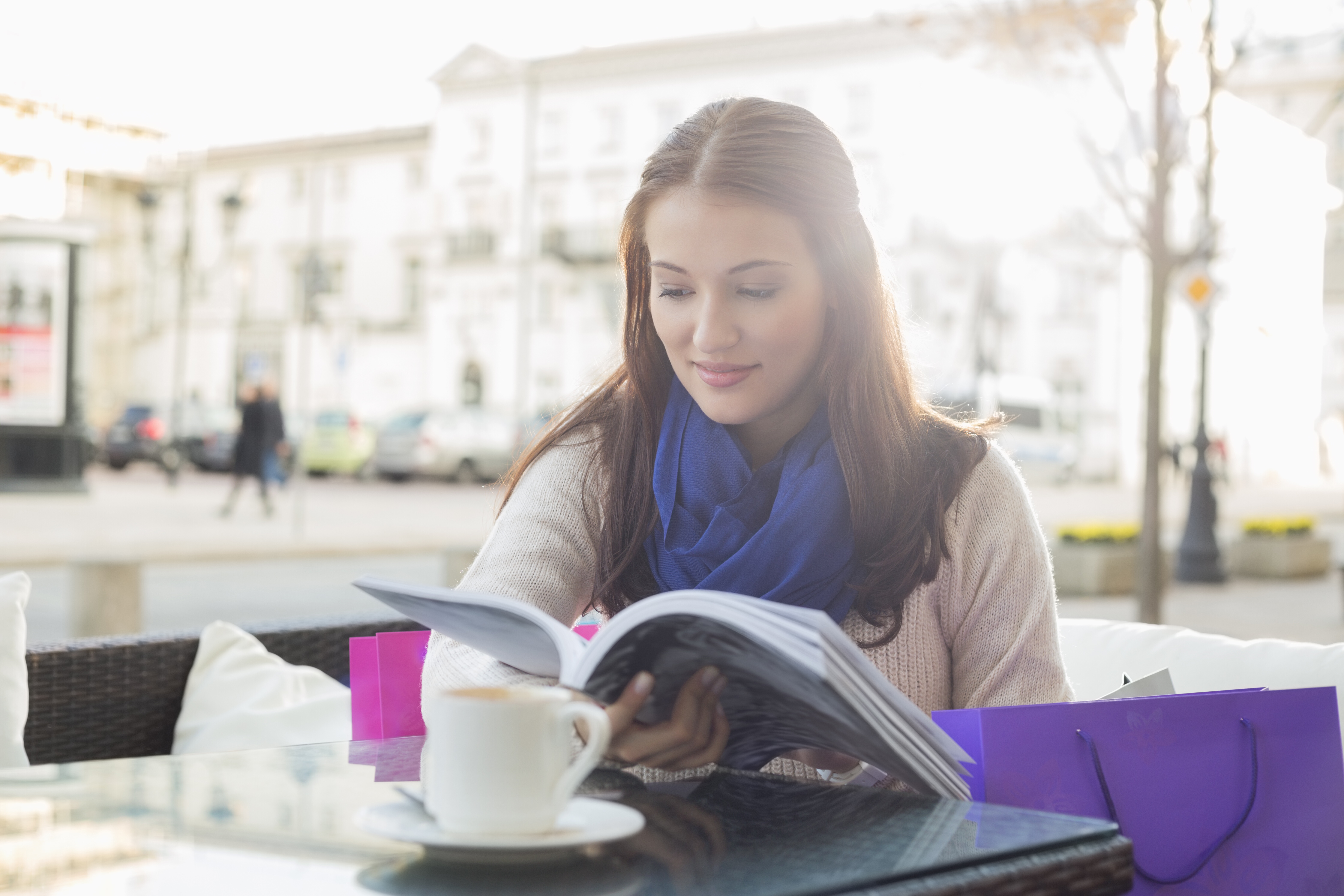 Woman reading a book at a cafe