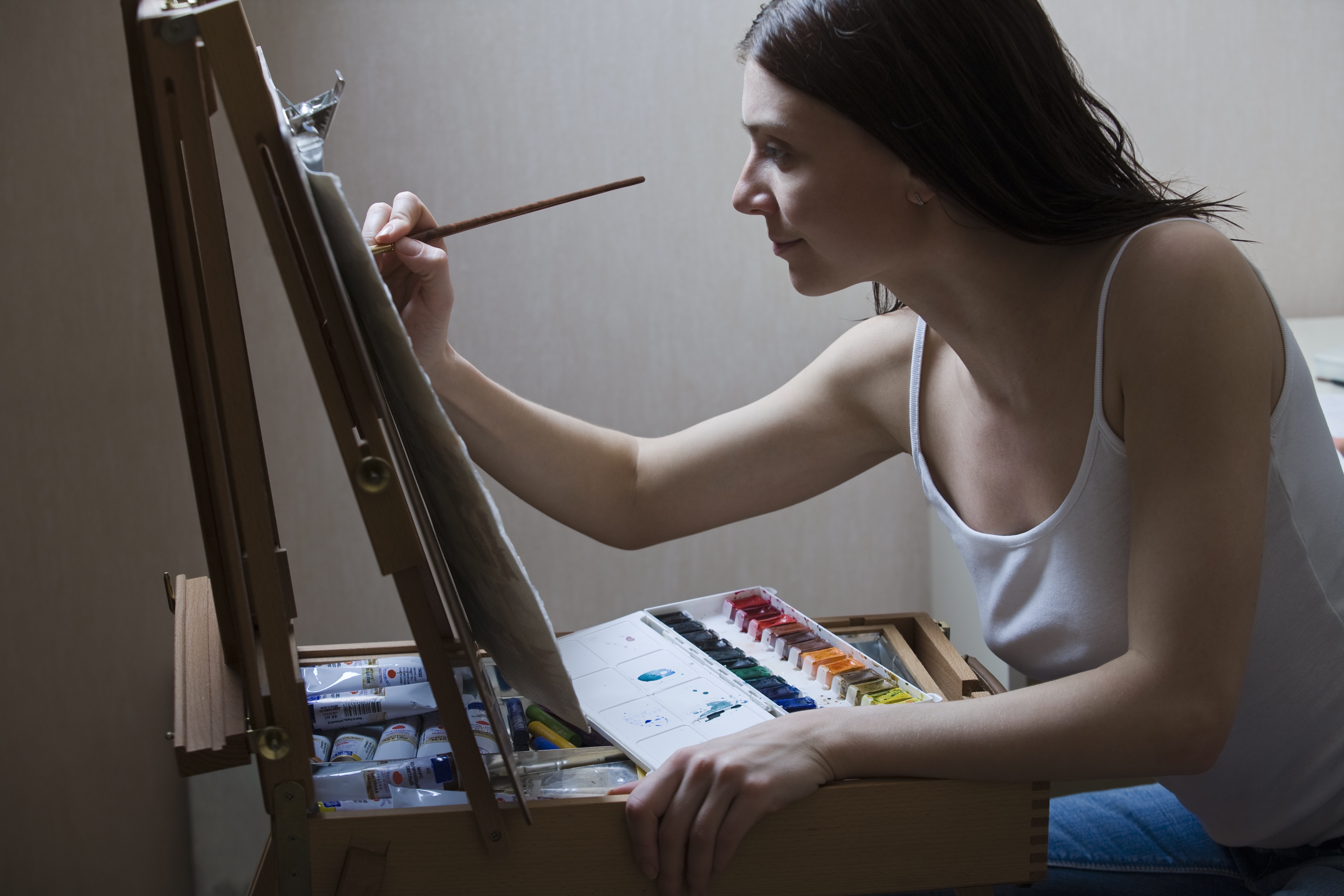 Woman painting at easel