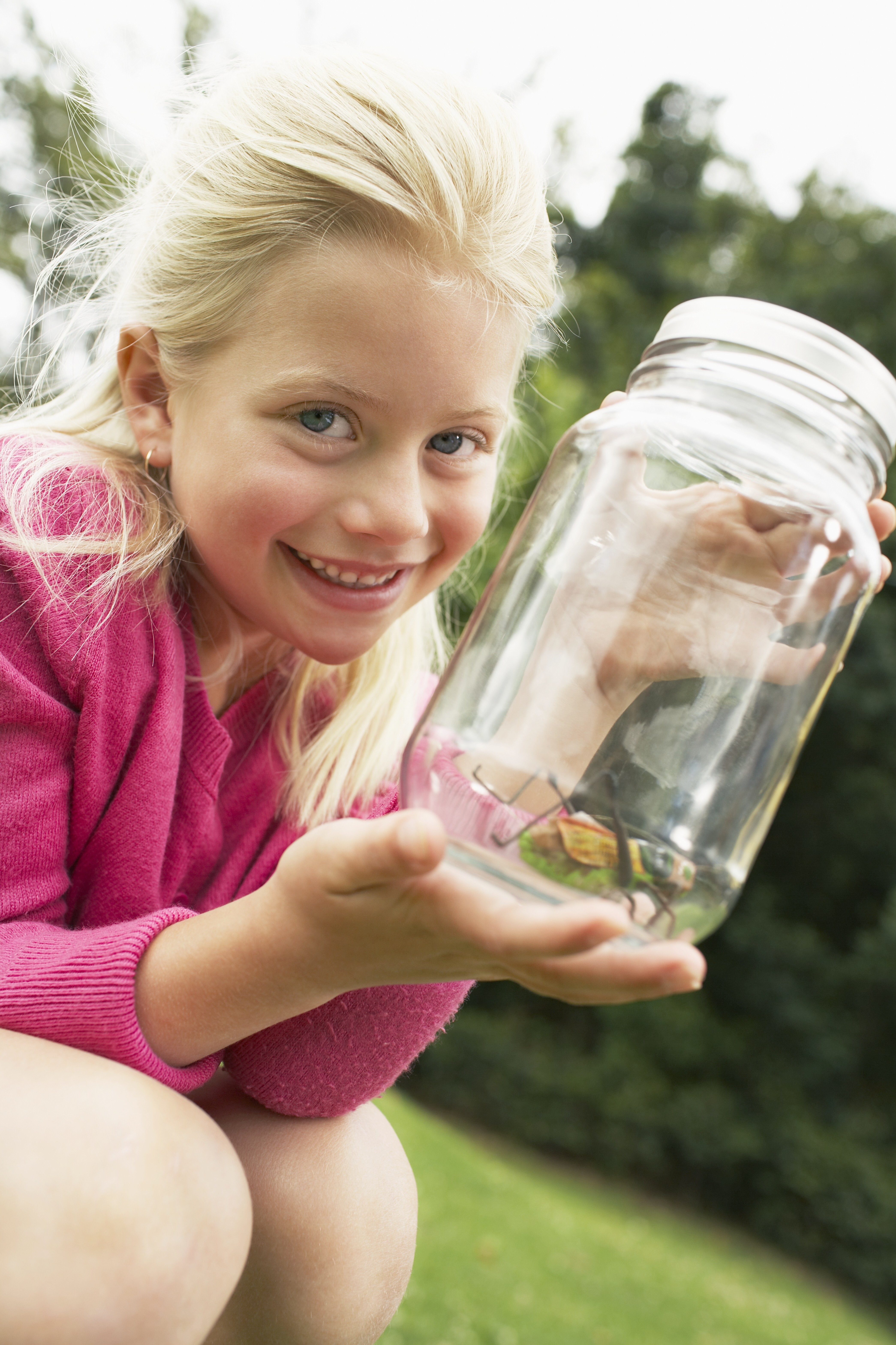 Child with a bug in a jar