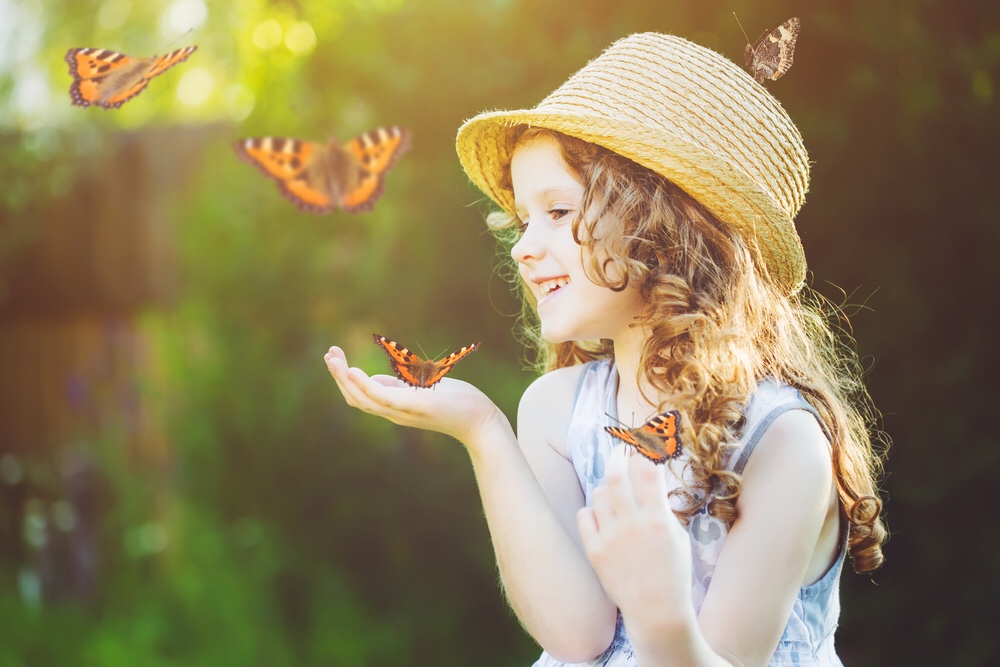 Girl holding butterfly