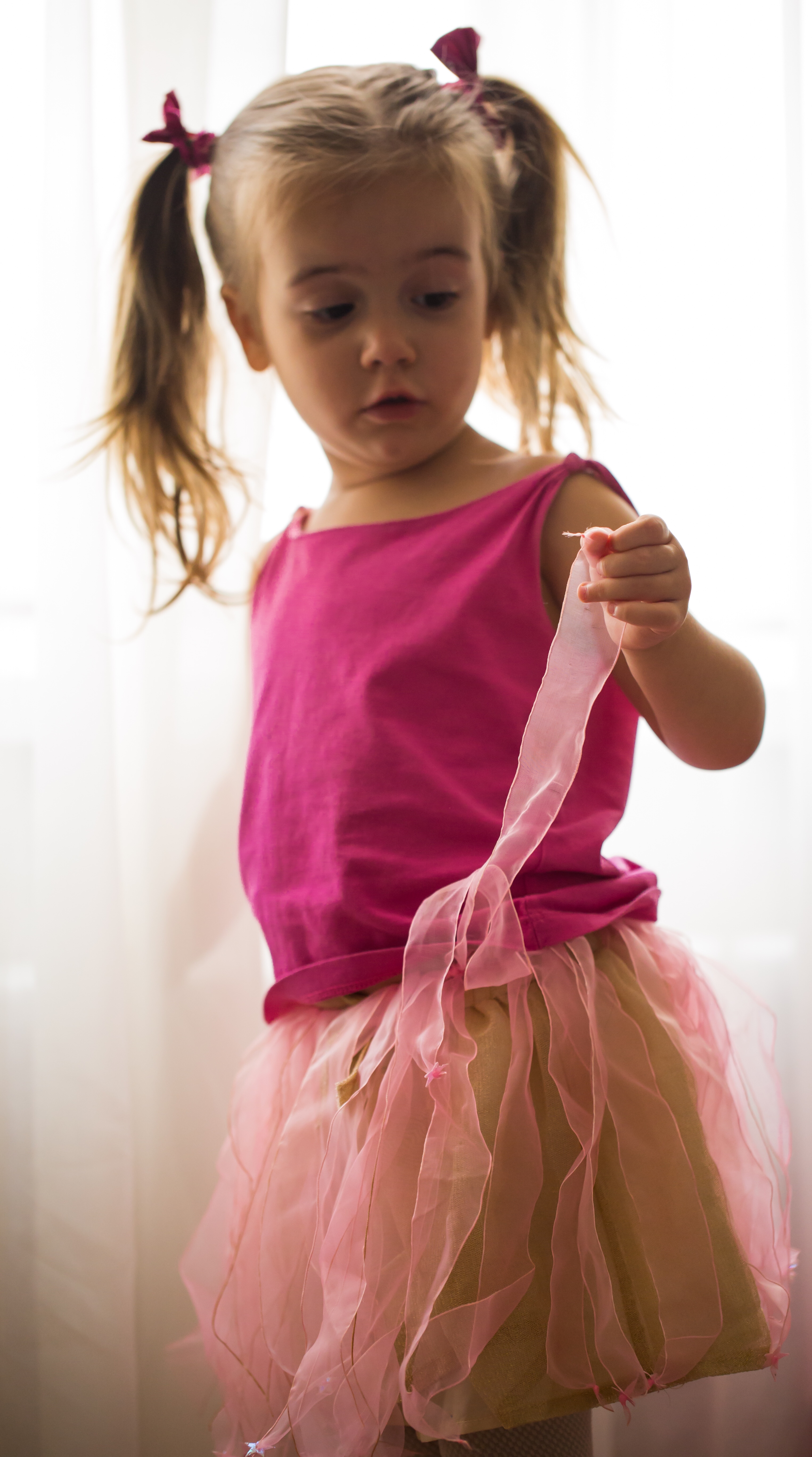 Girl in princess costume looking in the mirror