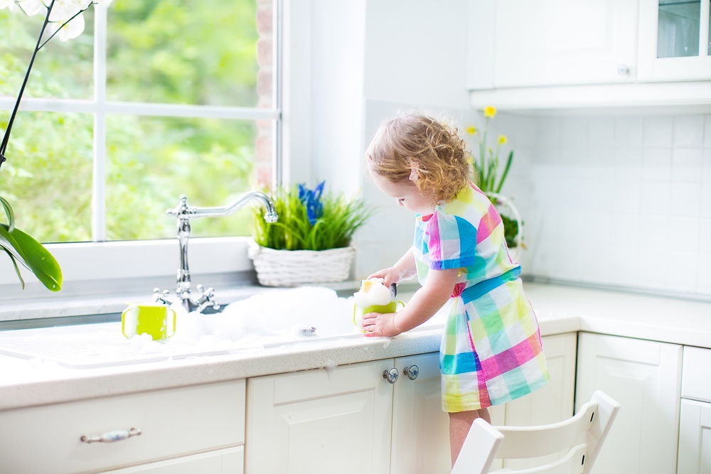 Toddler playing in sink