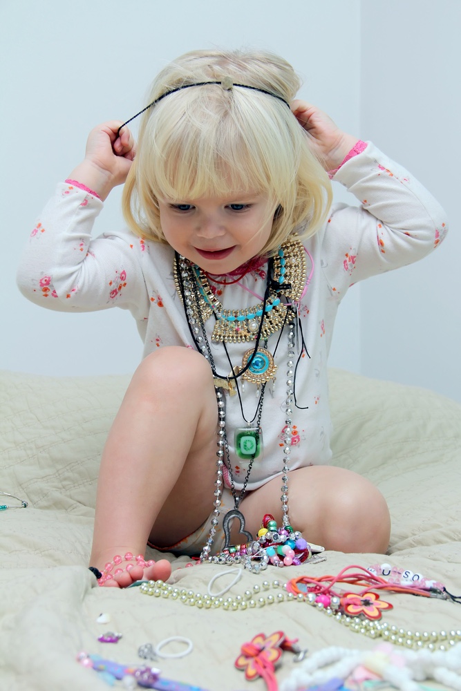 Little girl playing with jewelry