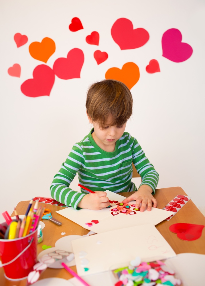 Kid making Valentine’s cards