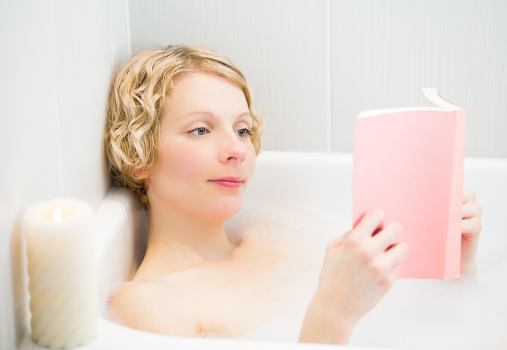 Woman relaxing in bubble bath.